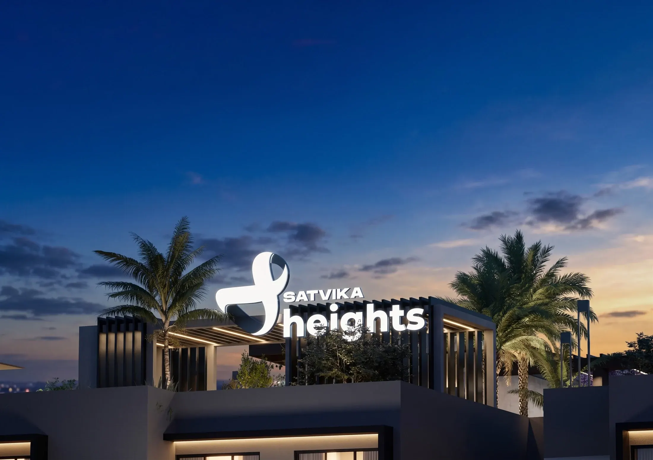 Illuminated Satvika Heights entrance signage, framed by palm trees at night