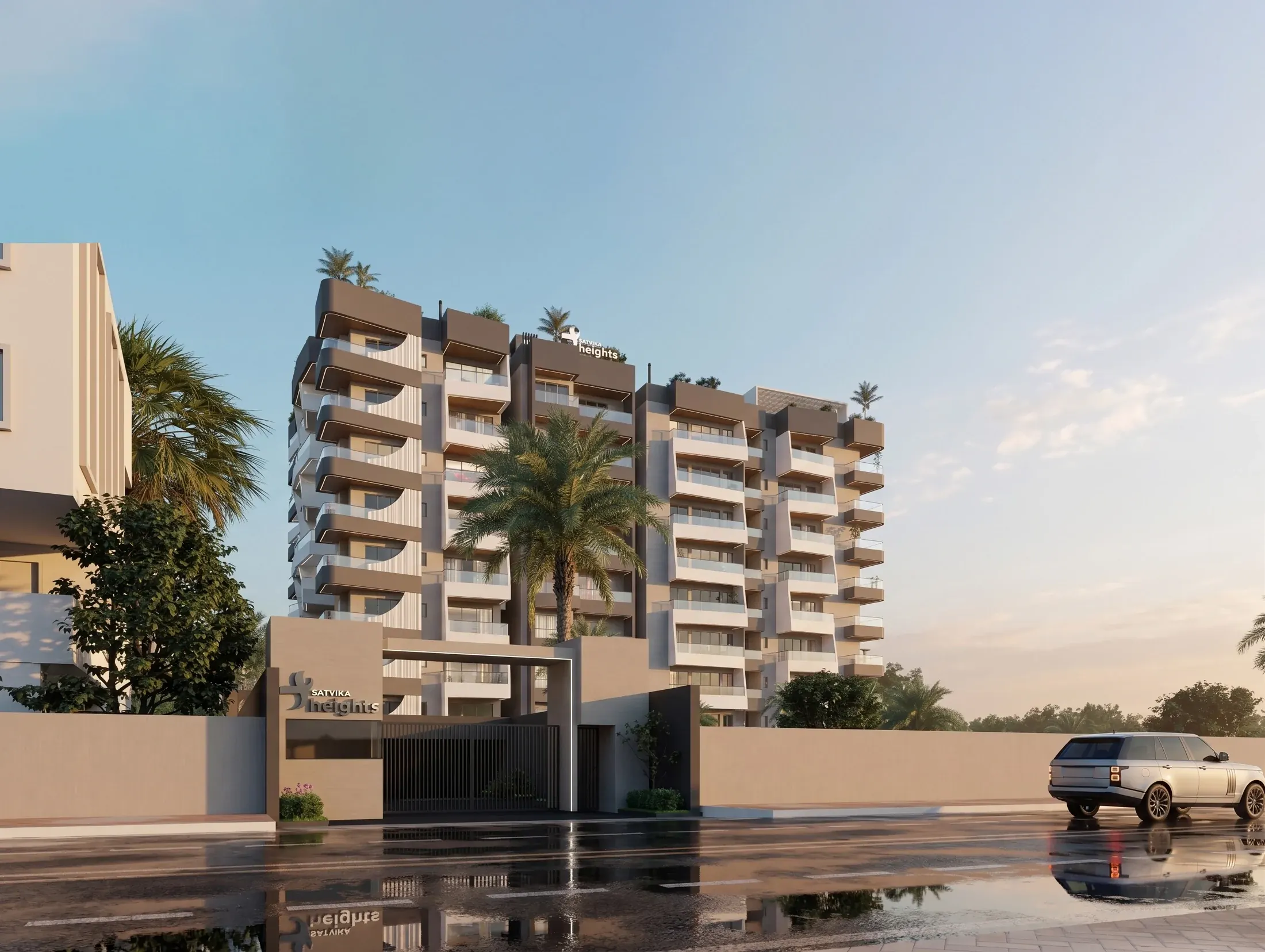Satvika Heights exterior, with repeating balconies, palm planting and a sheltered entrance