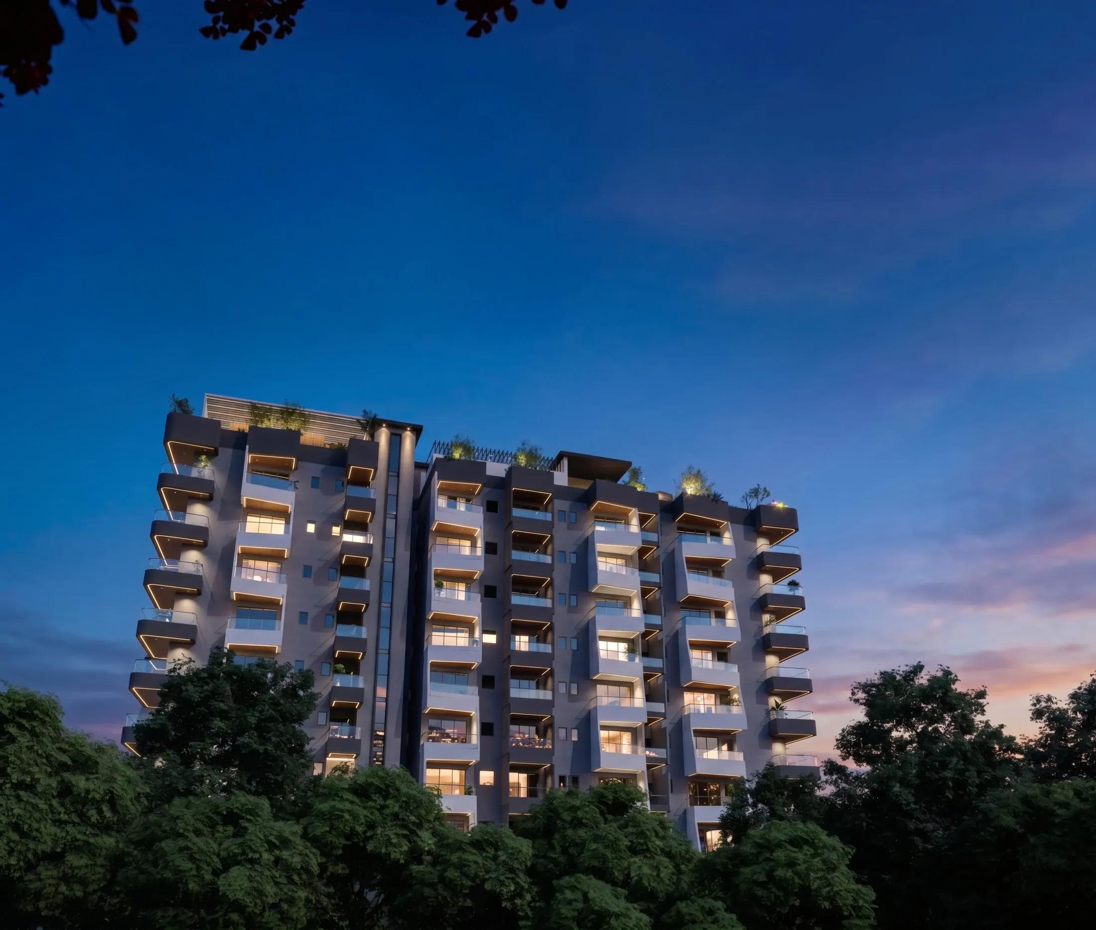 Satvika Heights illuminated at night beneath a deep blue sky
