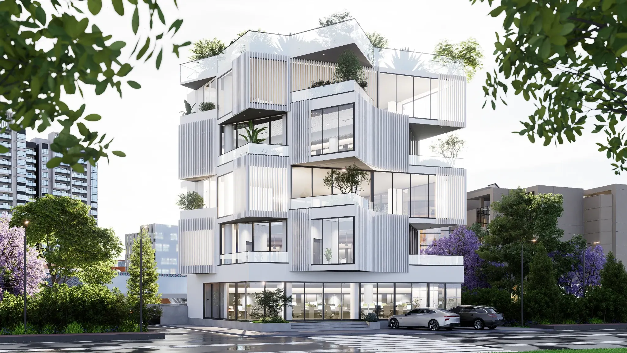 Street view of a white contemporary building with stacked volumes, screens, glazed corners and planted terraces